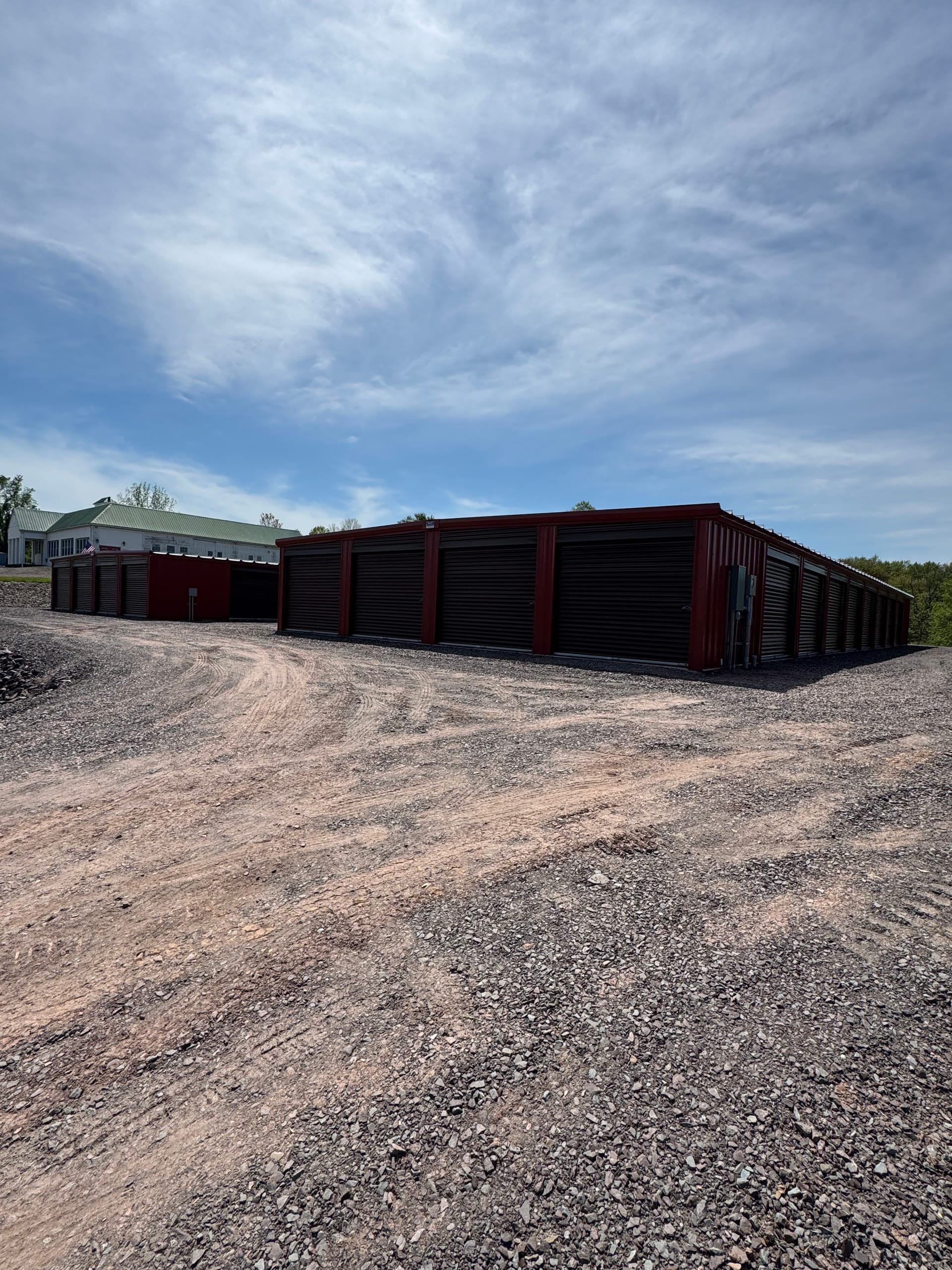 Rows of drive-up storage units with roll-up doors on the Greystone Storage property